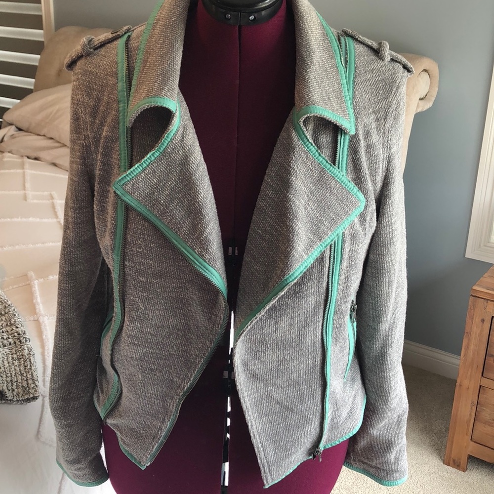 Gray jacket with teal detailing.